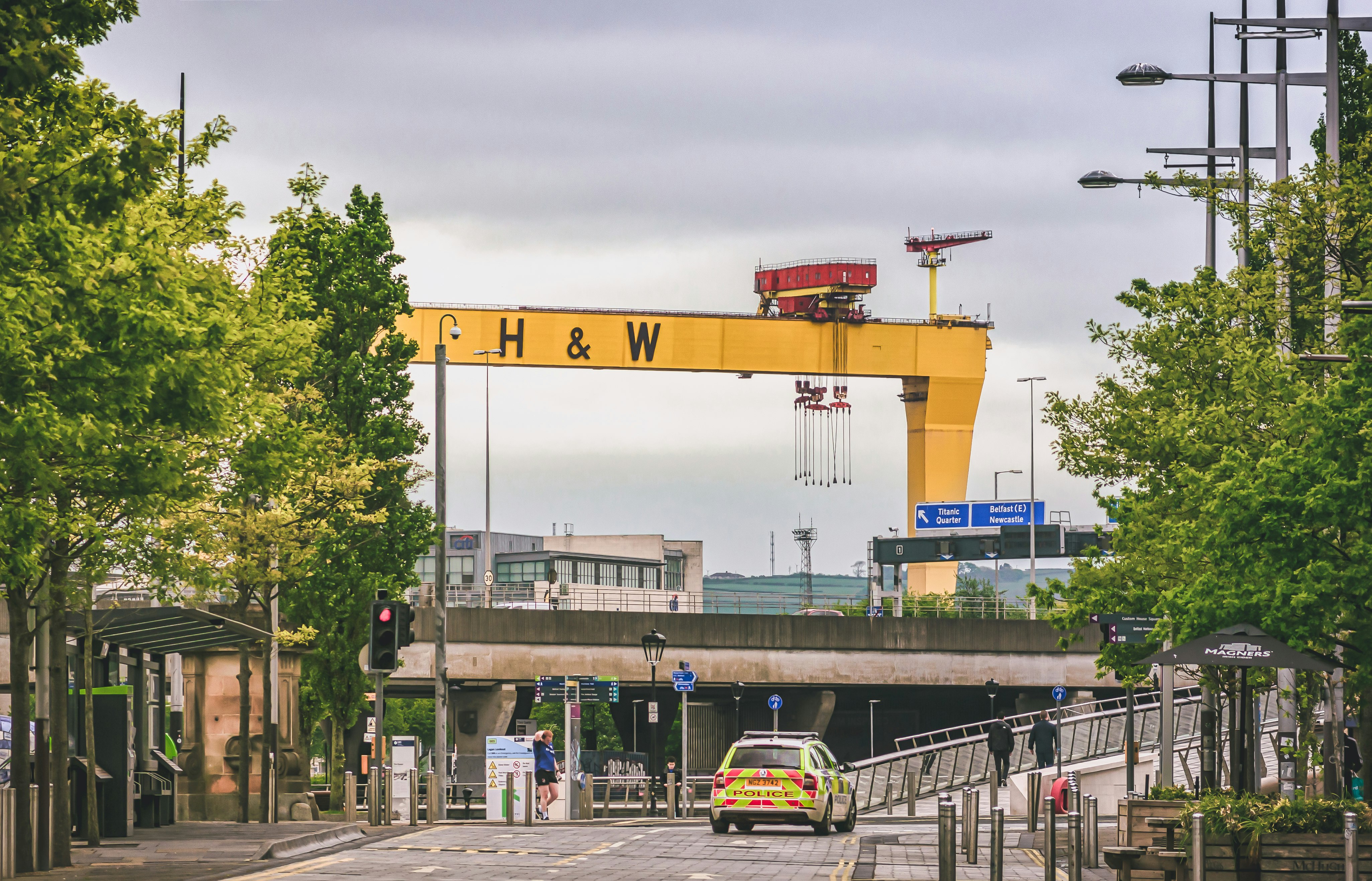 yellow and white crane near white and yellow bus during daytime